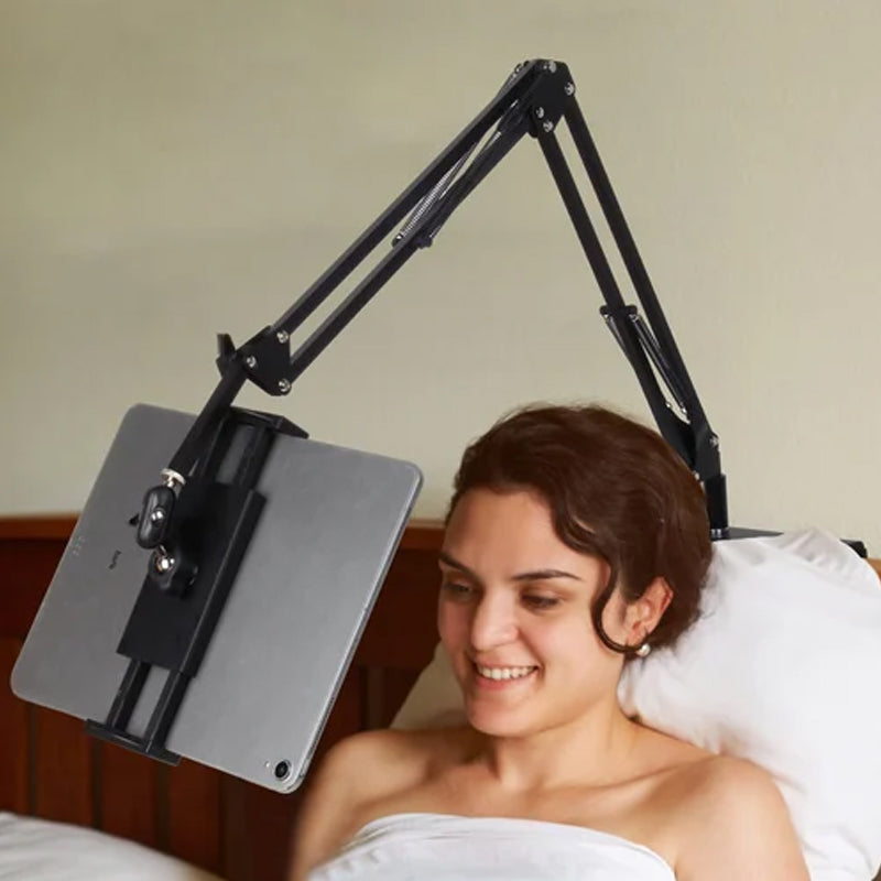 Extendable, concealed phone/tablet holder at the bed